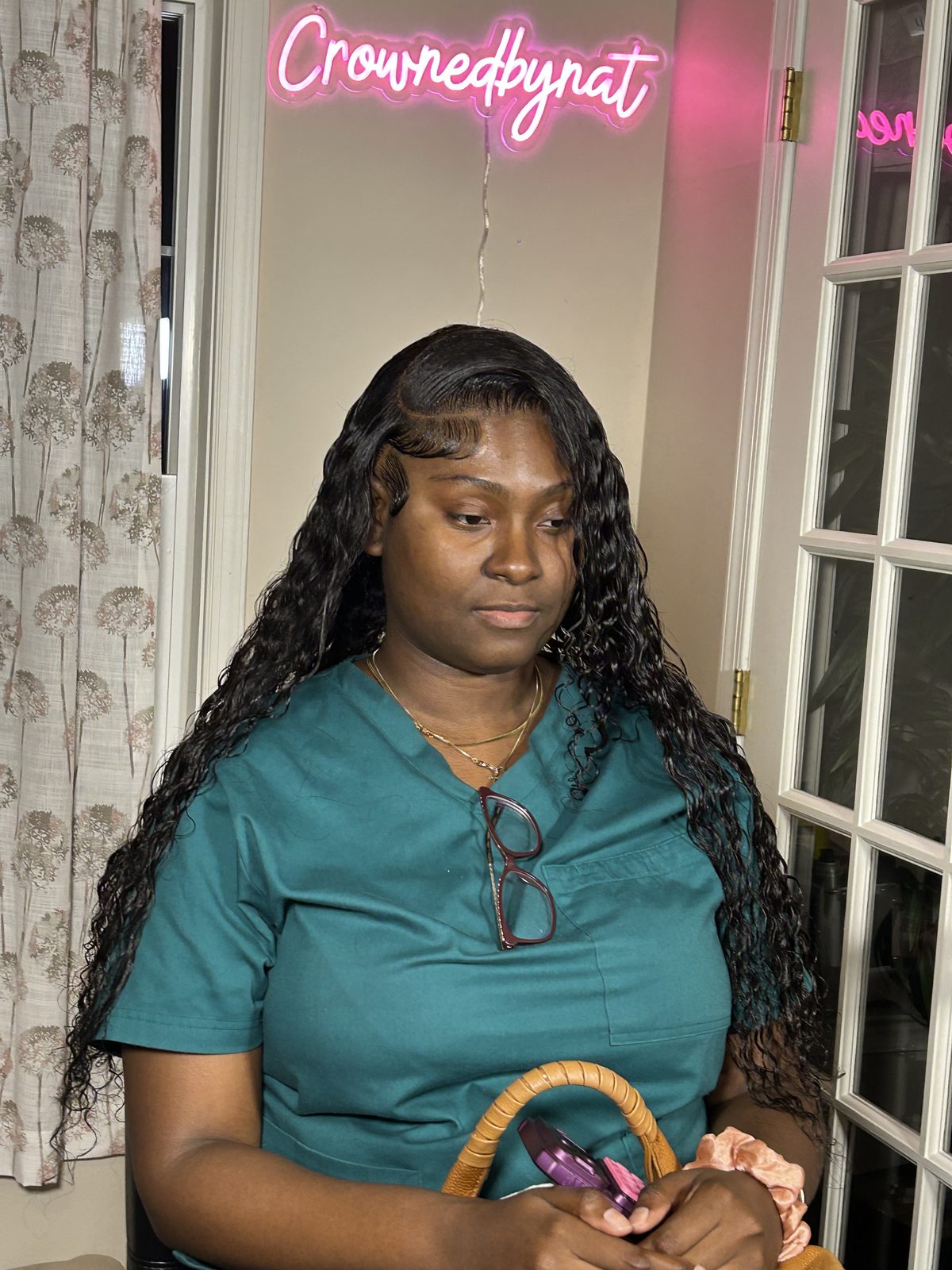 A deep-wave install with the front section braided back off the face and the baby hairs laid in fine curves along the hairline