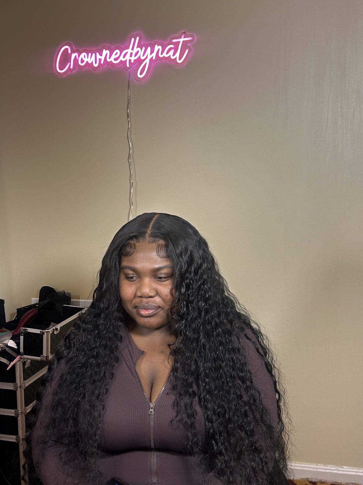 A long deep-wave install seen straight on, the centre parting sitting flat to the scalp with no visible lace edge